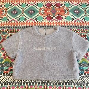 Lululemon Crop Sherpa with logo and button neck. Cute detail on back. Size 6